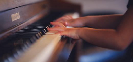 person playing upright piano